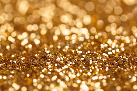 gold摄影照片_金色镀金质地的圣诞节抽象背景.Gold bokeh abstract background.