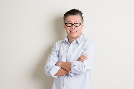 Portrait of mature Asian male arms crossed