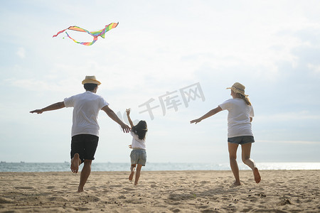 Happy Asian family travel together on beach on holiday. Family with beach travel. People enjoying with holiday vacation. High quality photo