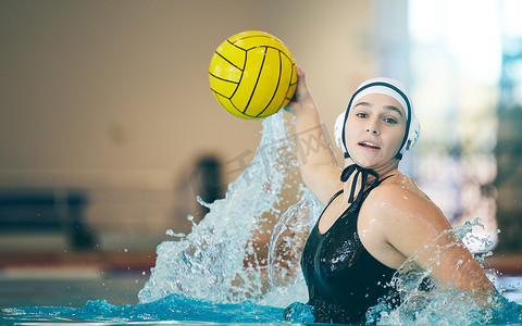 portrait摄影照片_Water polo, cardio and portrait of a woman with a ball for a competition, game and training. Fitness, strong and athlete girl throwing with power, action and playing during a professional match.