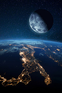 卫星月亮靠近蓝色的行星地球，夜间城市灯火通明。空间图像 
