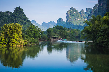 Scenic view of Yulong River among green woods and karst mountains at Yangshuo County of Guilin, China. Yangshuo is a popular tourist destination of Asia.
