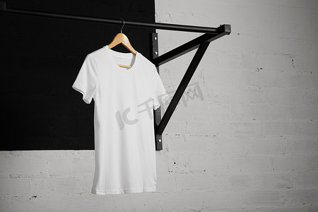 white t-shirt on cross fit pull bar in gym