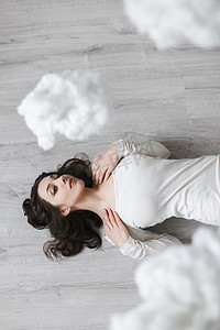 Picture of a girl lying on the floor in the clouds