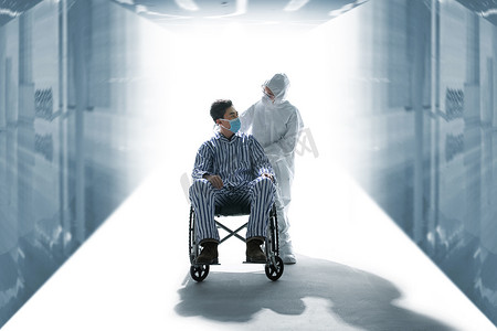 医务人员职业防护摄影照片_医务工作者推着坐轮椅的患者
