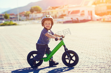 Little boy riding a runbike
