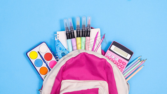 Backpack and school stationery on pastel blue background. Flat lay