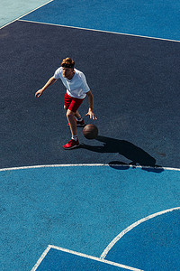 high angle view of young sportsman playing basketball on court