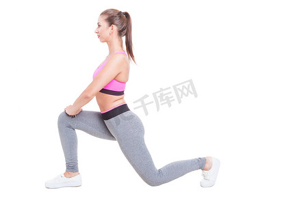 Young female working out standing in lunge position