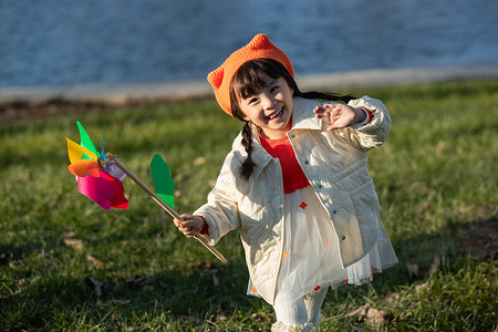 儿童风车摄影照片_可爱的小女孩在户外玩耍