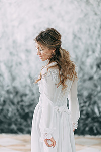 美丽的年轻新娘在闺房的衣服上的画布背景与油漆。婚礼的趋势和想法 2018, 春天的灵感。婚礼在演播室