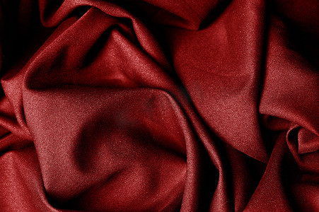 红布盖着的车摄影照片_纹理，背景，图案，红布。优雅的针织母体