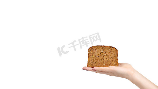 Hand with slice of brown bread with seeds, heathy food. Isolated on white background. Copy space, template.