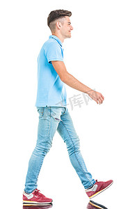  young casual man walking on isolated background.
