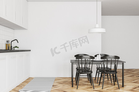北欧风格的厨房, 白色的墙壁, 木地板, 白色的台面和橱柜和桌子与黑色的椅子侧面视图。3d 渲染模拟