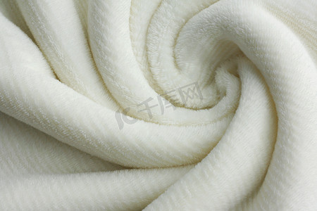 白毯子摄影照片_柔软的白毛毯旋流背景