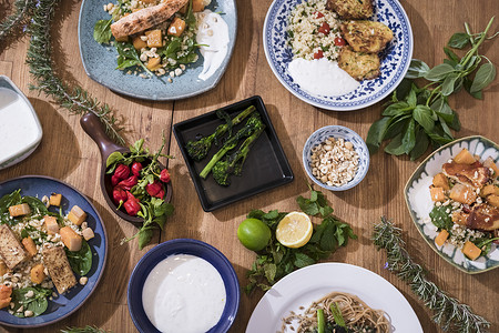 豆腐摄影照片_烤蔬菜和健康的食物盘放在精美的木制桌子上.地中海菜，配以芦笋、豆腐、塞丹和哈卢米奶酪。适合健身人士的无麸质食谱。食物背景