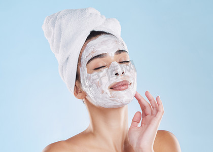 routine摄影照片_Skincare woman, beauty facial mask and cosmetics after fresh shower, bathroom grooming routine and bodycare on blue background. Feminine face, clean spa pores and healthy pamper treatment complexion.