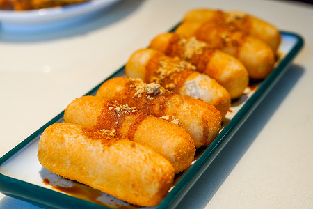 A plate of traditional Sichuan snacks, cakes with sugar and oil