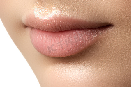 Close-up of woman's lips with fashion natural beige lipstick makeup. Perfect Lips. Sexy Girl Mouth close up. Beauty young woman Smile. Natural plump full Lip. Lips augmentation. Close up detail