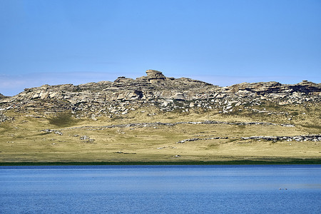 located摄影照片_Beautiful summer steppe landscape and Ayr (Monastyri) Lake, located in stone mountains 
