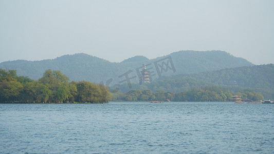 The beautiful lake landscapes in the Hangzhou city of the China in spring with one old temple tower located on the shore