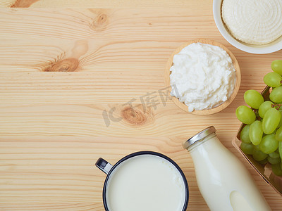 Milk and cheese, dairy products, fruits on wooden background. Jewish holiday Shavuot concept. Top view