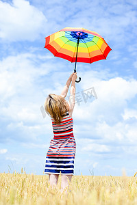 Image of elegant romantic woman having fun holding up umbrella on blue sky copy space background outdoors