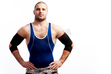 年轻体育人在蓝色紧身衣和黑手肘站立在白色被隔绝的背景