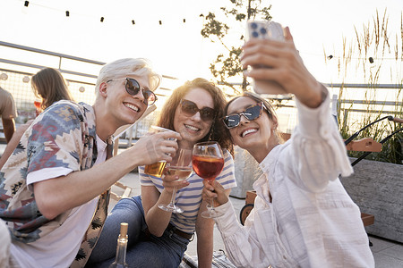 Group of friends make a selfie together in top of the roof