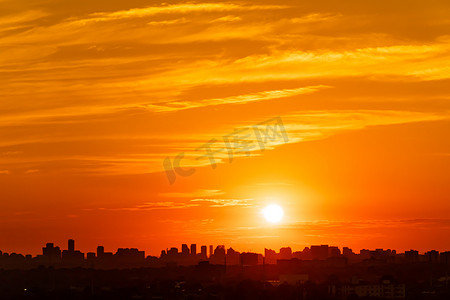 炎热摄影照片_多伦多加拿大城市景观天际线景观炎热炎热的夏夜日落.橙色的黄昏，太阳光和云彩。气候变化概念。戏剧化的云彩景观.