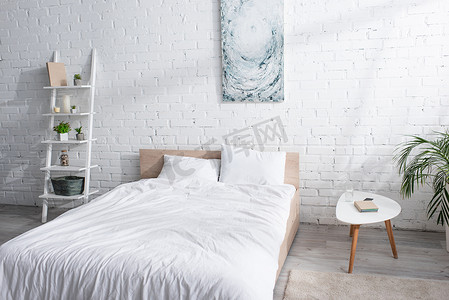 现代卧房有白色被褥的床 