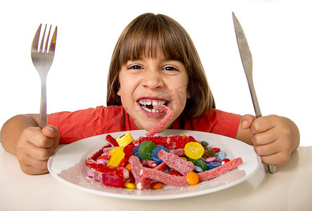 child eating candy like crazy in sugar abuse and unhealthy sweet nutrition concept