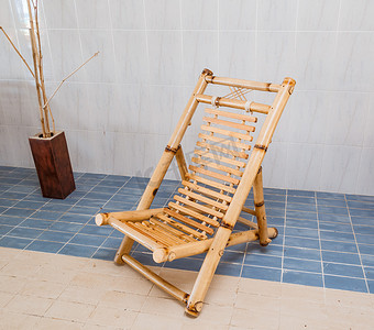 amazing beautiful stylish natural bamboo chair standing on blue and biege  ceramic floor