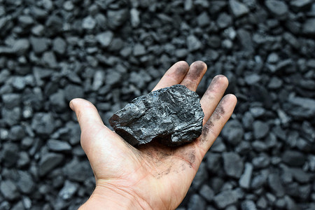 能源开采摄影照片_矿工的手显示我的煤。图片可用于煤炭开采、能源或环境保护的理念.