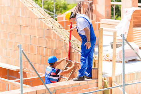 Worker checking walls on construction site