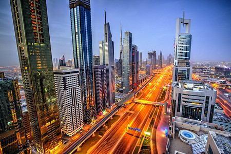 Dubai sunset panoramic view of Burj Khalifa with Sheike Zayed road. Dubai is super modern city of UAE, cosmopolitan megalopolis.