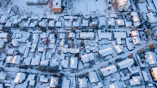 上面的景色是在雪白的房屋的屋顶上，冬天是寒冷的城市景观.  