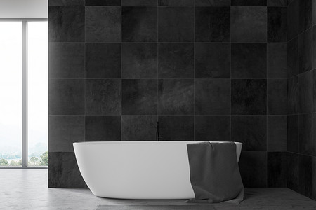 简约的浴室内部有黑色瓷砖墙，混凝土地板，大窗户山景和白色浴缸与灰色毛巾。3d 渲染