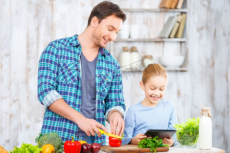 Happy father and daughter cooking together