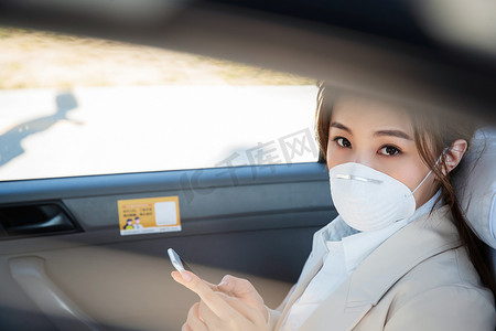 年轻女人戴口罩乘坐汽车
