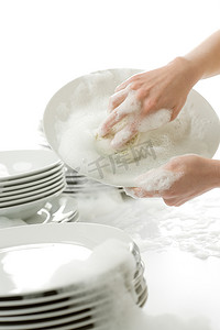 厨房套摄影照片_洗盘子-戴着手套在厨房里的手