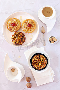 大粒核桃摄影照片_法式糖果: 核桃焦糖馅饼和杯咖啡。光背景上的顶部视图