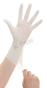 医生带上白色孤立的无菌手套的手。医疗