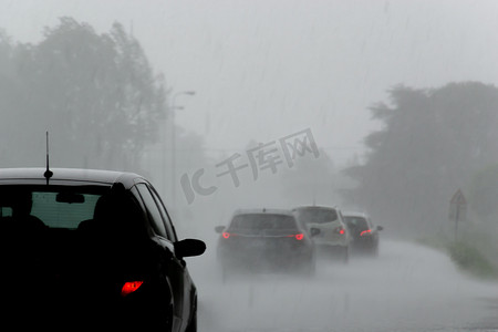强风暴与大雨在路上与汽车能见度低。恶劣天气下驾驶危险的概念.