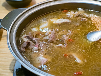 Fresh delicious mutton hot pot with vegetables and Chinese herbal medicine.