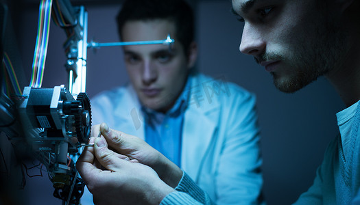 Engineering team working on a 3D printer