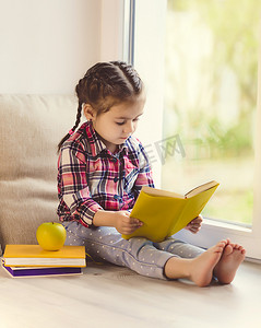 天天半价摄影照片_可爱的小学步女孩看书坐在窗口阳光明媚的春天天