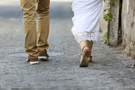 Young couple walking outdoor. Male and female legs. 