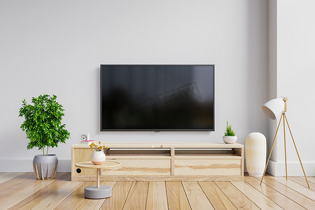 欧美风看电视摄影照片_LED电视在现代客厅的橱柜上，白墙背景。